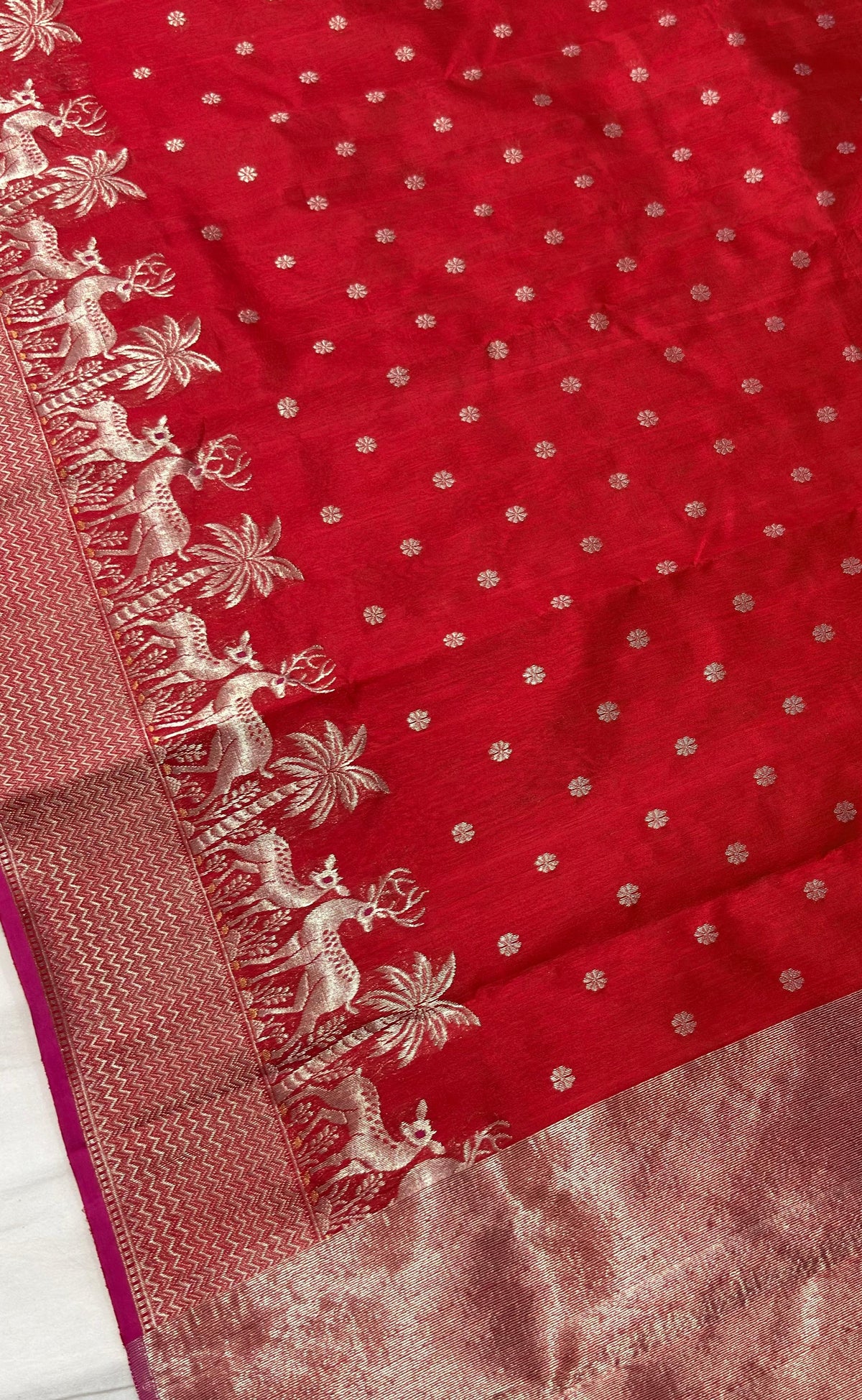 Crimson red Pattu Silk Chanderi saree with silver floral dots and deer motif zari border