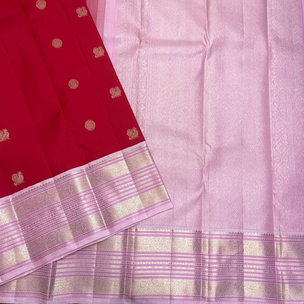Rose-pink woven Kanchipuram pallu with subtle chevron geometry and luminous metallic detailing.