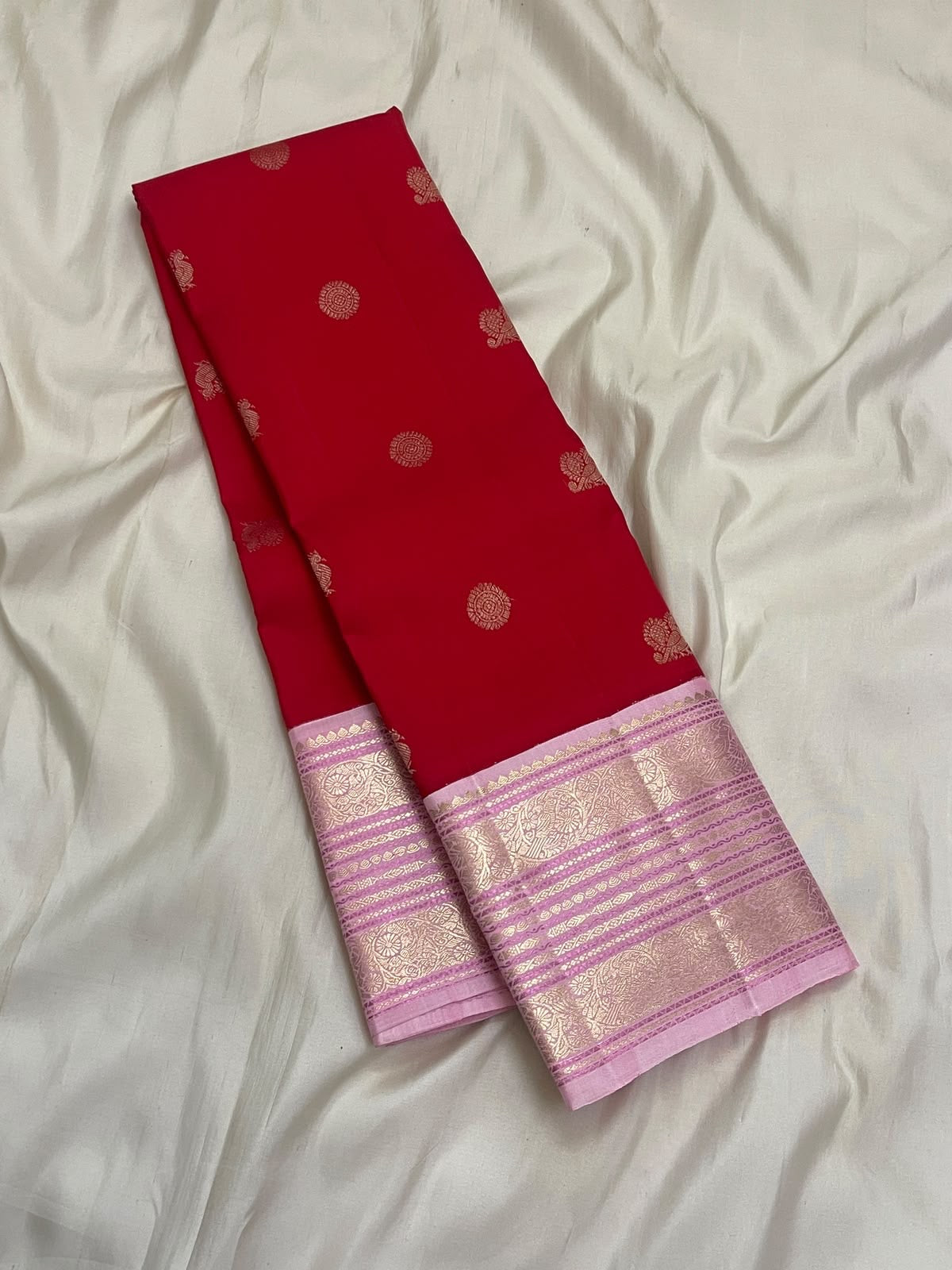 Crimson red Pure Silk Kanchipuram Butta saree with ornate rose-pink zari border and contrast woven pallu.
