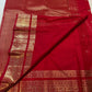 Close-up of scattered gold-zari florals on crimson Kancheepuram silk body