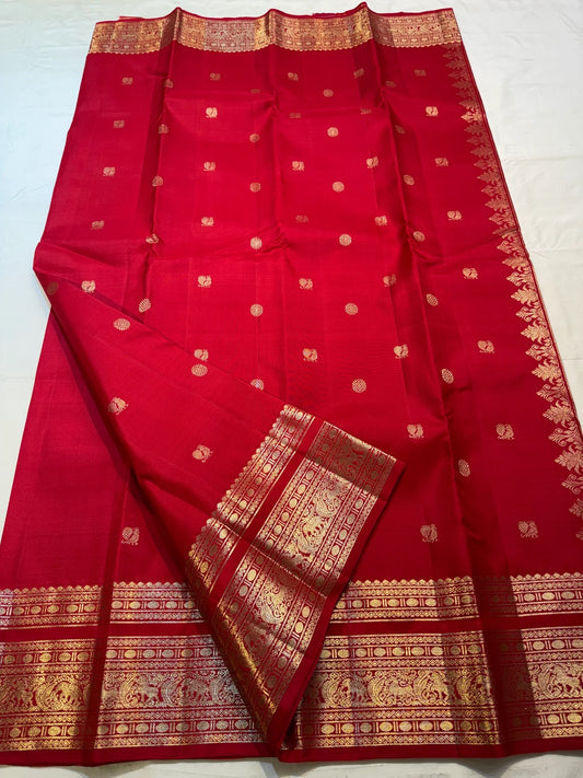 Gold Varisaipet multi-band border with peacock and elephant motifs on crimson Kancheepuram saree