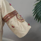 Side angle of cream silk Tanjore Treasure designer blouse with intricate embellishment