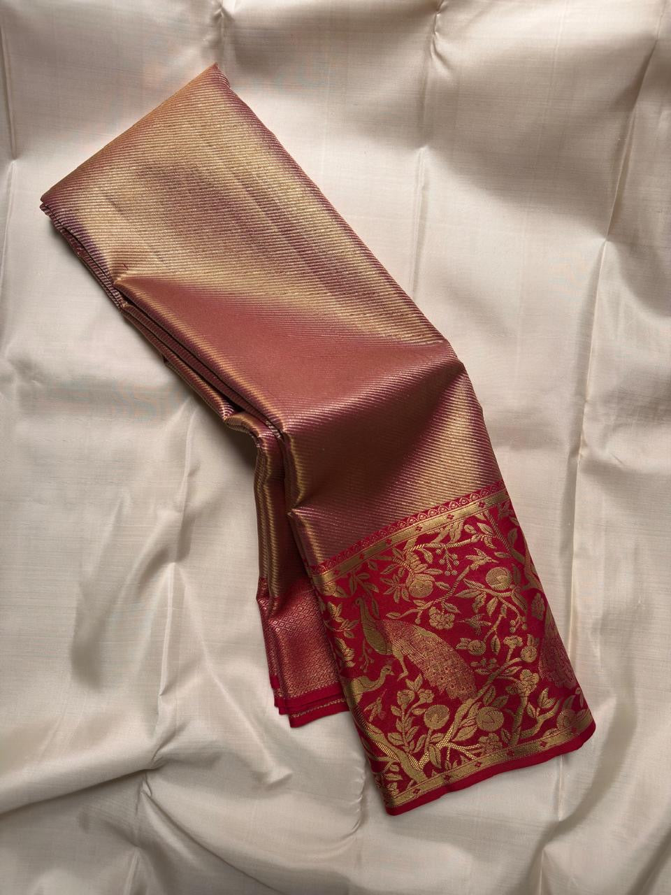 Dense champagne-gold Kanchipuram silk body with fine chevron zari lines
