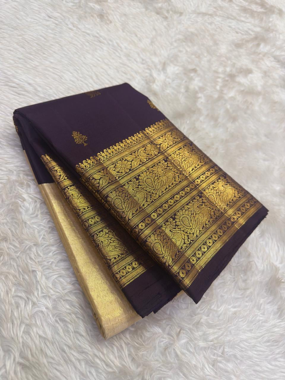 Aubergine purple Pure Silk Kanjivaram saree showcasing handwoven peacock motif zari craftsmanship