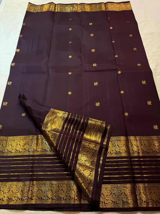 Deep Kanchana Brown handwoven pure silk saree with small gold zari buttas and traditional bird panels.