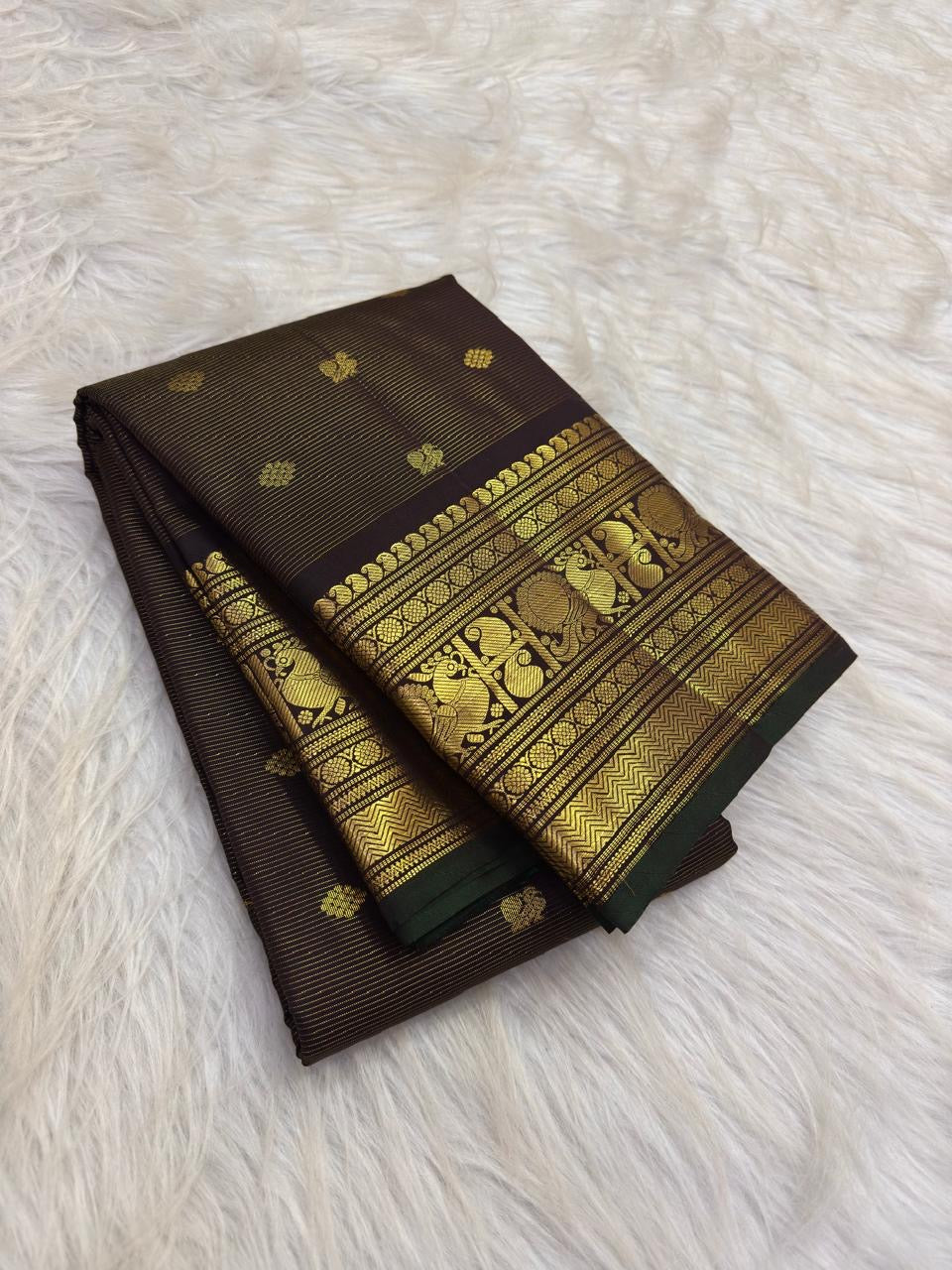 Dark Brown Kanchipuram silk saree showing a lightweight kanchipuram body animated by fine vairaoosi needle-like linear striping and small spaced zari buttas.