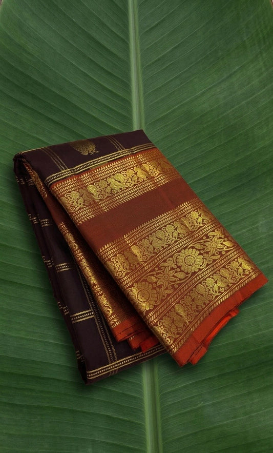 Kanchipuram silk saree in dark cocoa brown with burnt orange border Varisaipet Korvai weave folded view