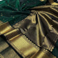 Full view of Deep Emerald Green Katan Silk Chanderi saree with gold floral buttas and broad ornamental gold border.