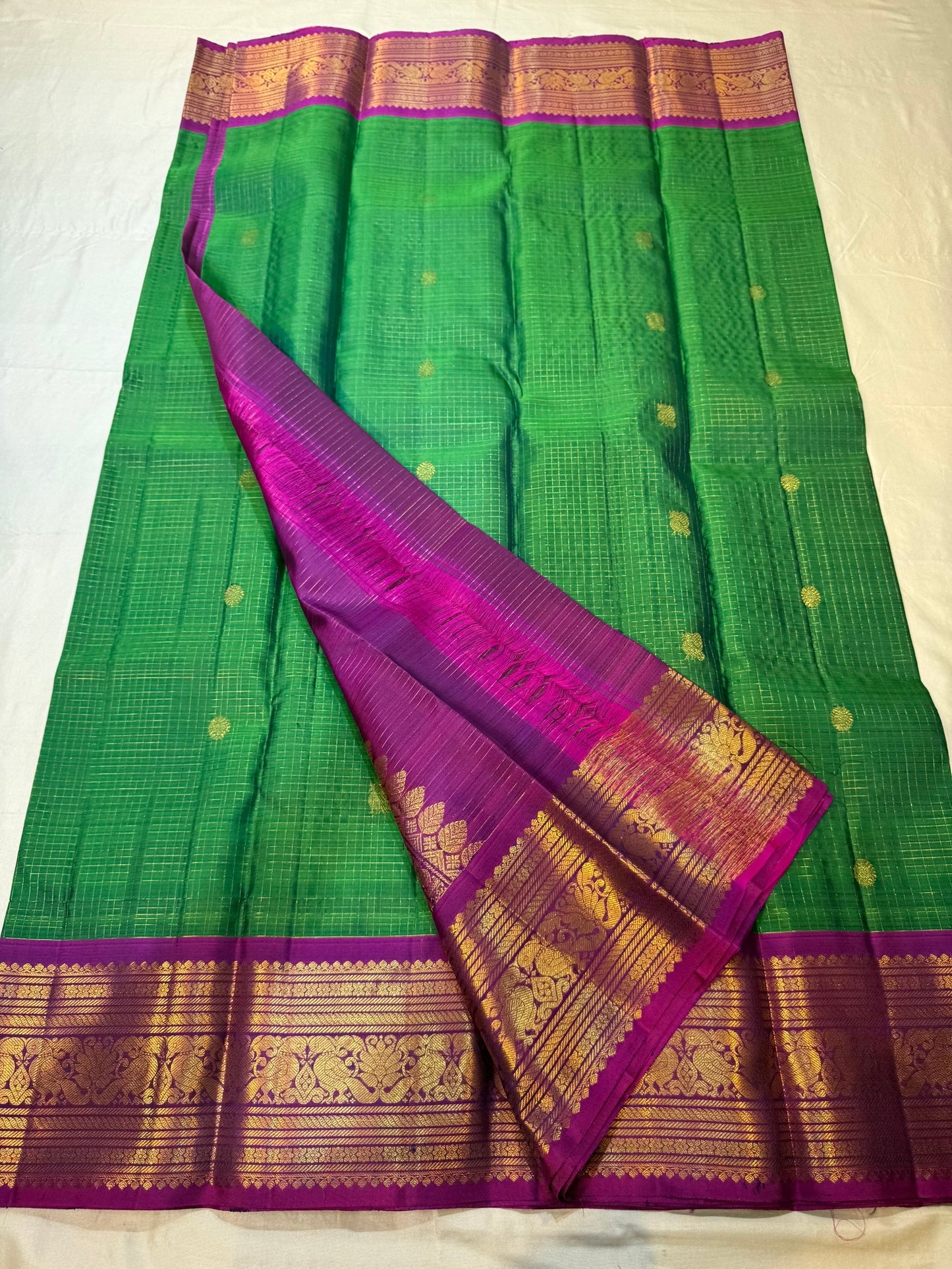 Magenta border with dense gold zari vanasringaram panels on forest green KanchiPattu saree — Idam Living