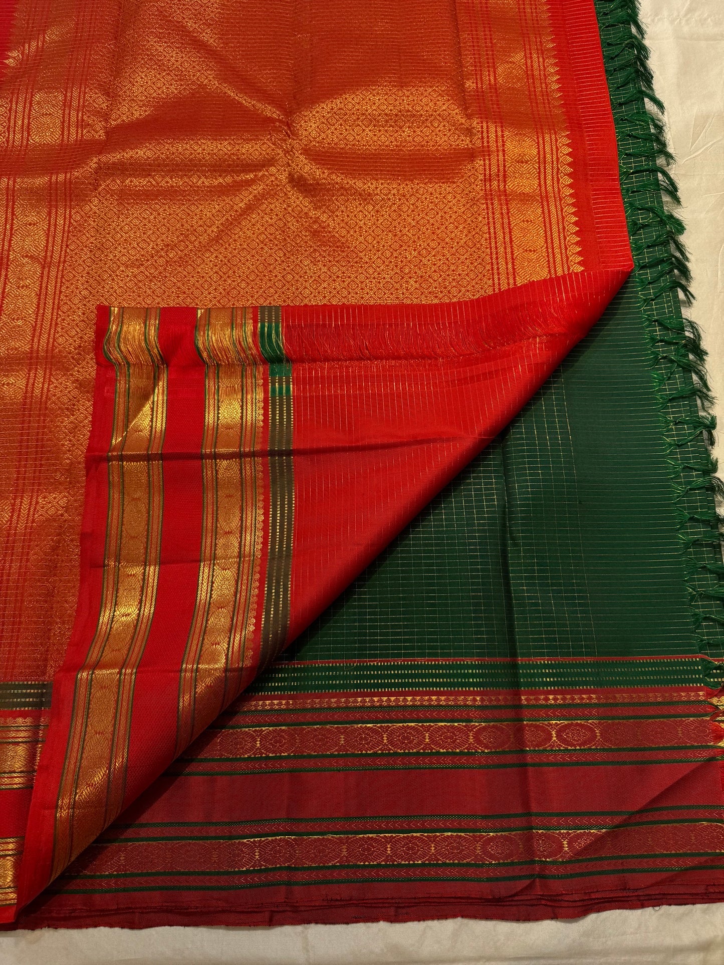 Folded view of bottle green and arakku red zari kattam Kanjivaram silk saree — Idam Living