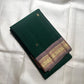 Pure Kanchipuram silk saree folded showing green body with gold zari paisley border