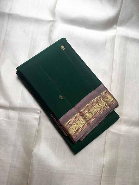 Pure Kanchipuram silk saree folded showing green body with gold zari paisley border