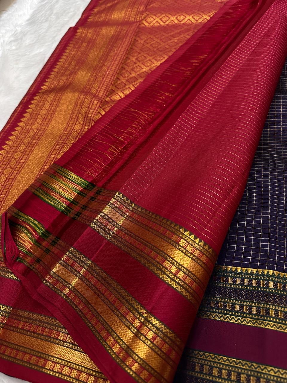 Maroon pallu of Pure Kanchipuram silk saree with gold zari woven geometric pattern and wide zari woven border bands