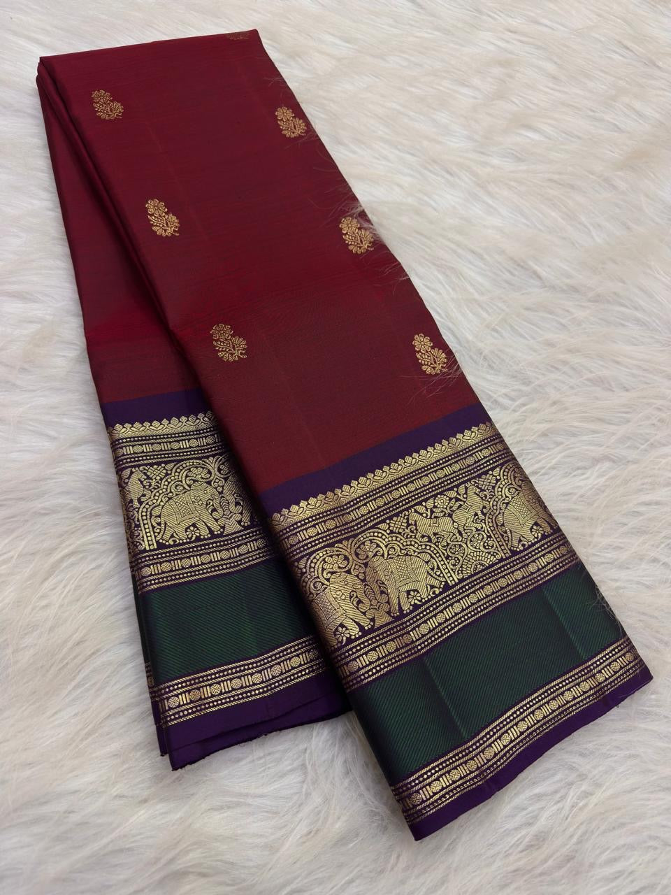 Deep Arakku Maroon Pure Silk Kanchipuram Butta saree with a Yaanai gold-zari border.
