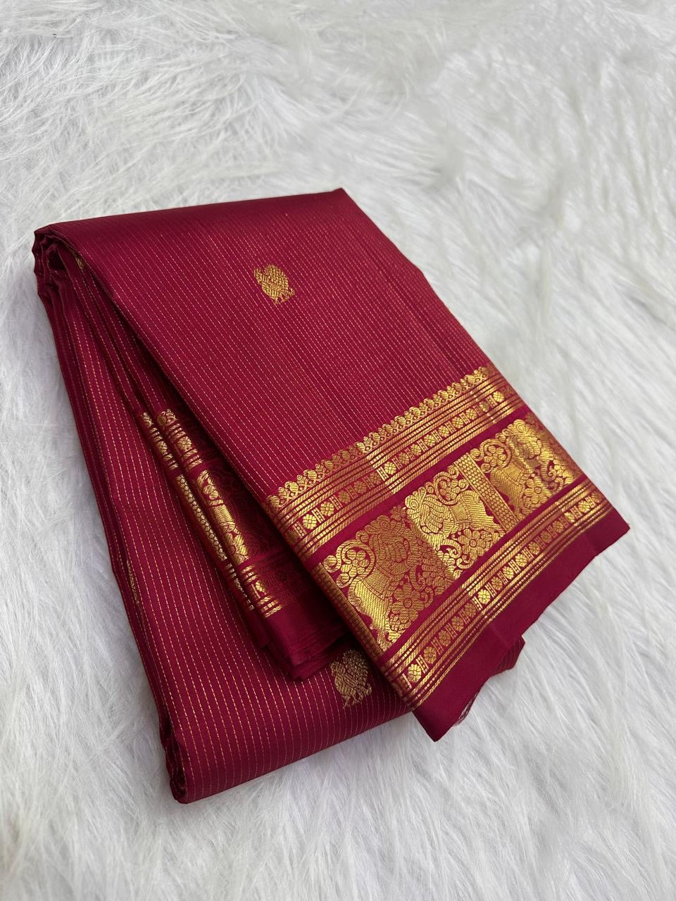 Deep red Kanjeevaram saree with majestic Yazhi border