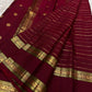 Close view of framed Mayil motifs woven in warm gold zari on Deep Arakku Red border.