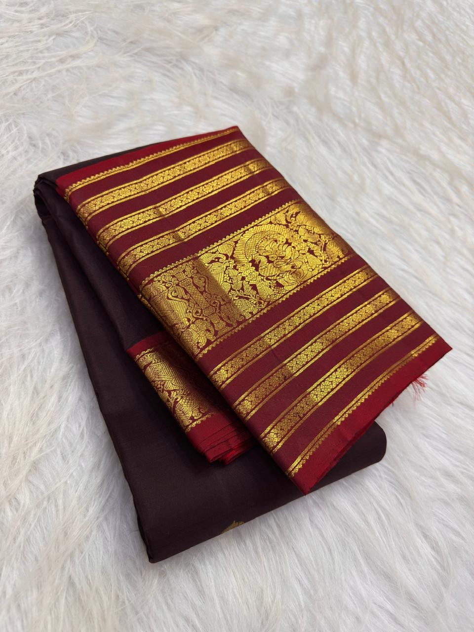 Dark aubergine brown Kanchipuram silk body with individually spaced gold zari buttas.