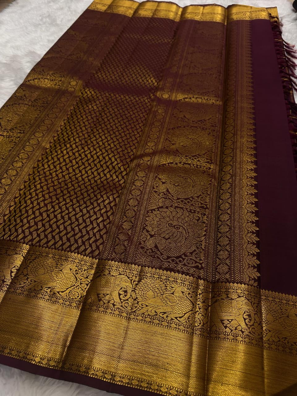 Deep Aubergine Kanchipuram silk saree with antique gold Zari Kattam grid, full drape view.