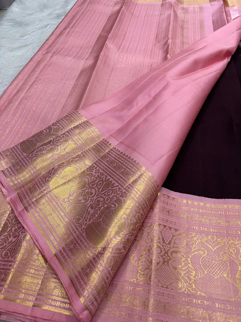 Deep Aubergine Brown pure mulberry silk saree with small spaced zari motifs and broad pink-gold border.
