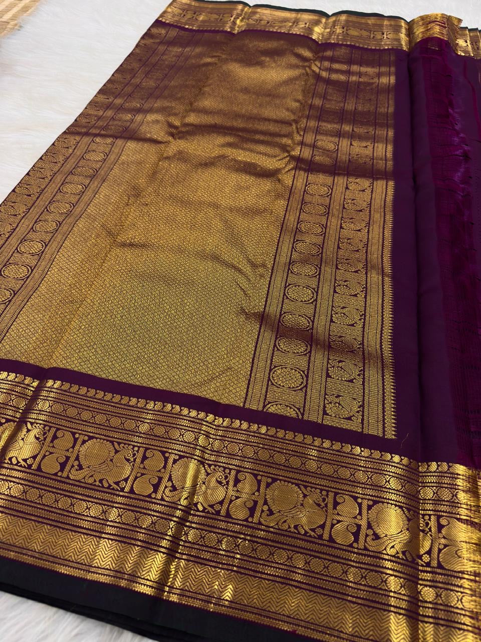 Deep purple Kanjeevaram saree with Mayil border
