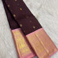 Deep brown aubergine Kanchipuram silk saree with spaced gold zari motifs and contrasting pink Korvai border.