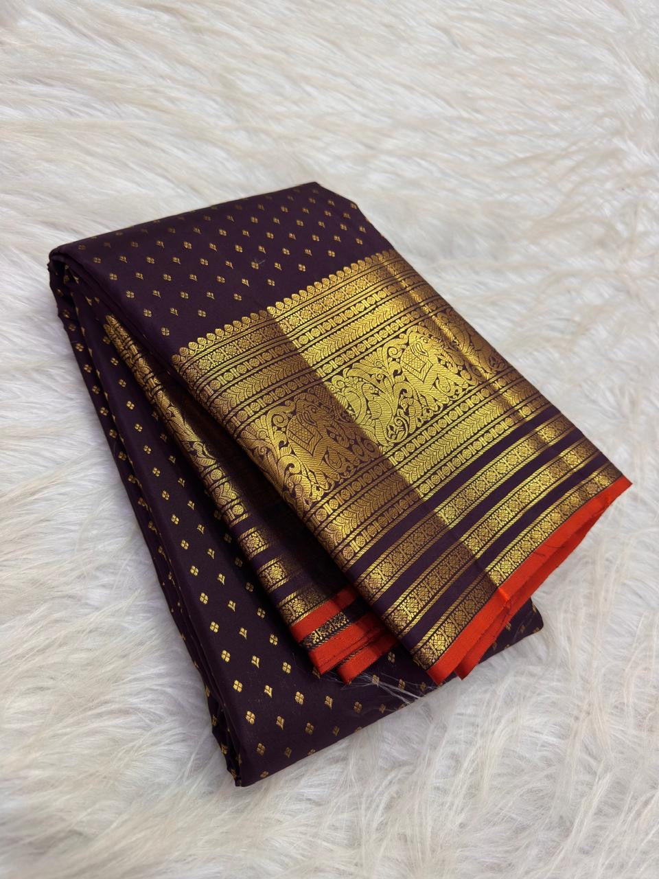 Deep Brown Kanchipuram silk saree with petite handwoven gold zari buttas.