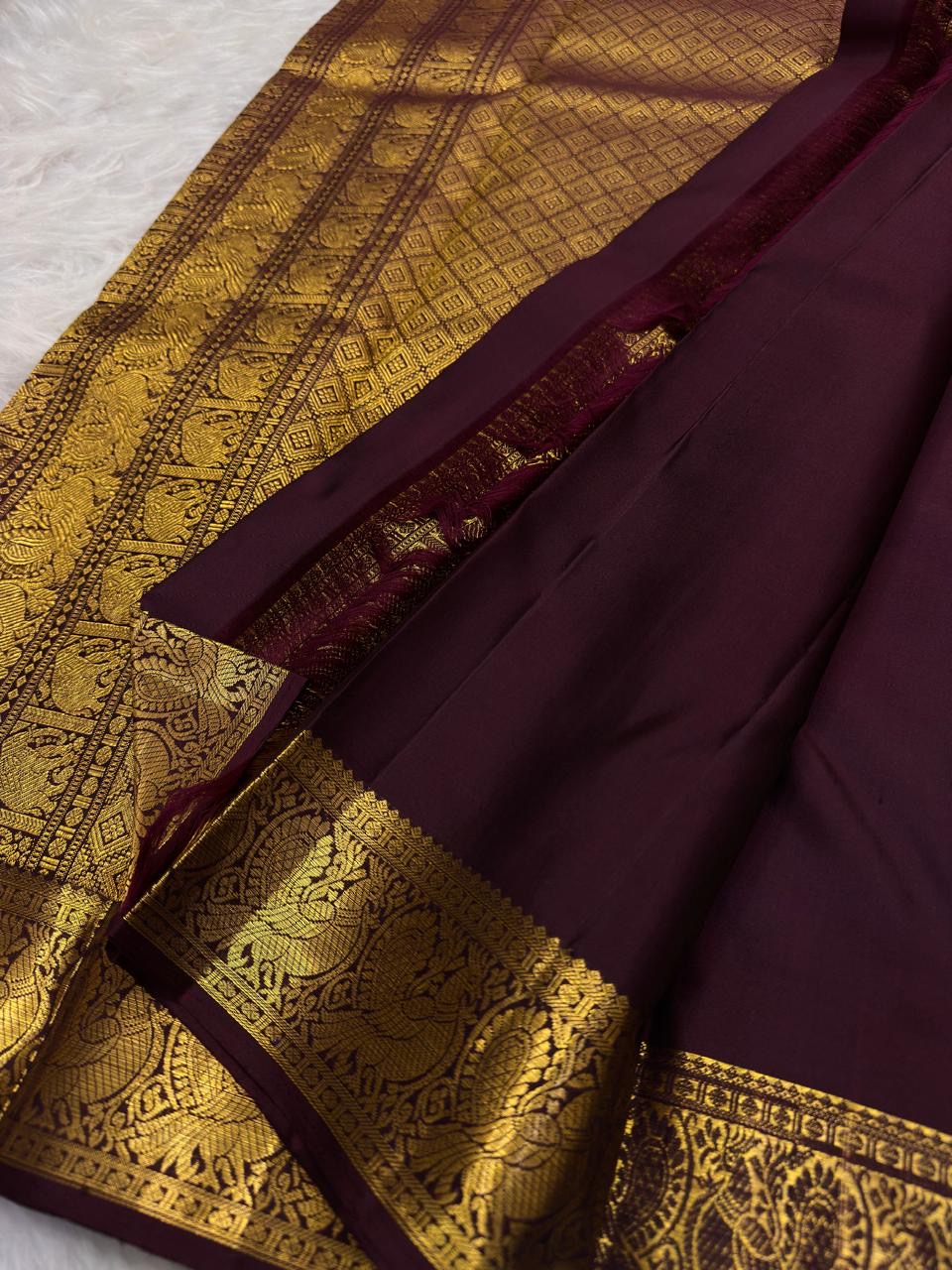 Deep aubergine Pure Silk Kanjivaram Butta saree with antique gold zari motifs and Mayil border
