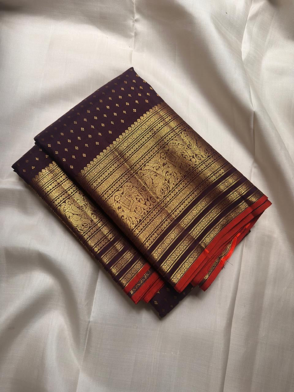 Deep Aubergine Purple handwoven pure silk Kanjivaram Butta saree with fine antique-gold zari buttas.