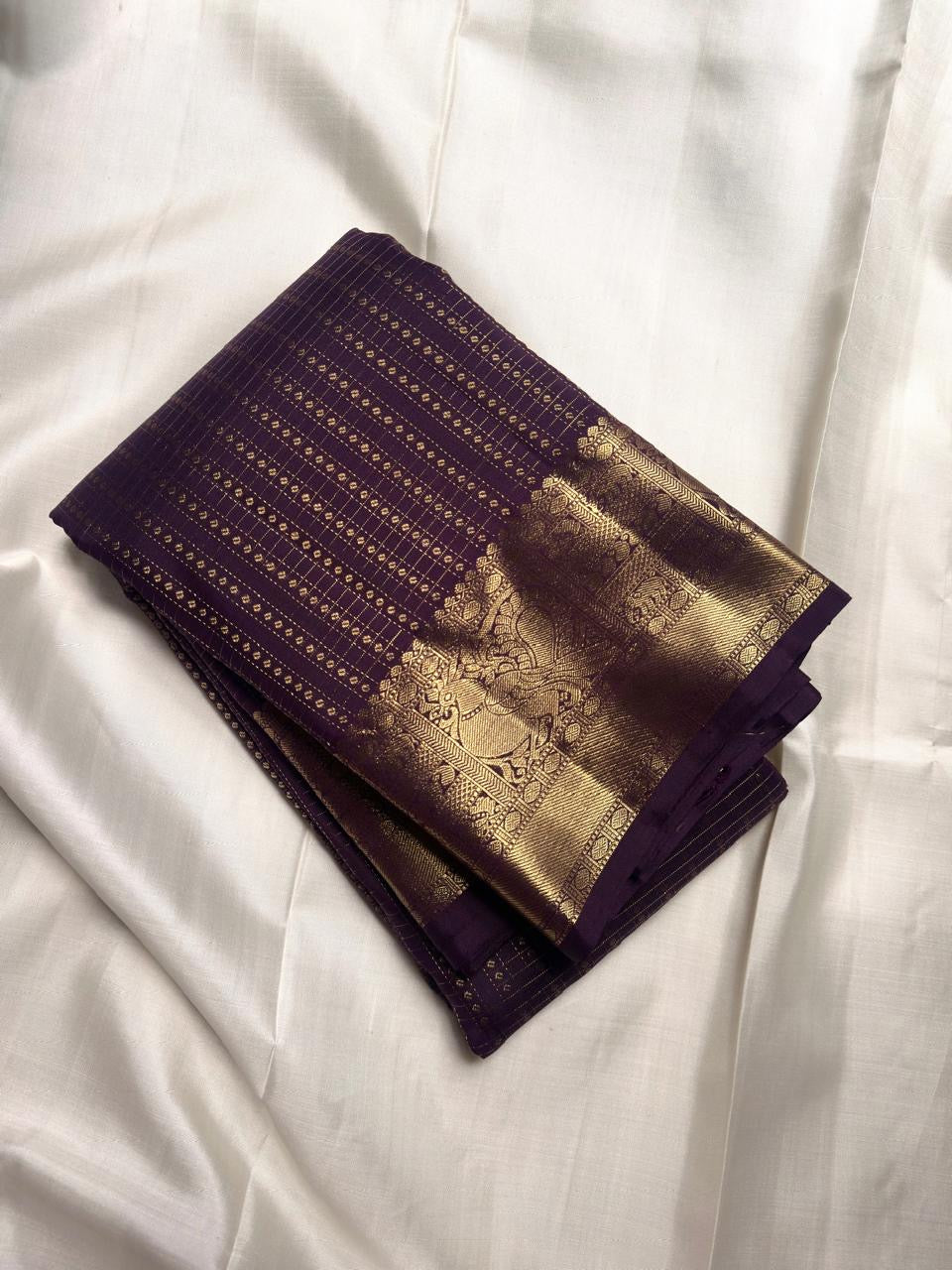 Deep Aubergine Purple handwoven pure silk Kanjivaram Butta saree with antique-gold zari.