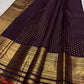 Deep Brown pure silk Kanjivaram Butta saree with purple Kanchana undertone and antique-gold zari border.