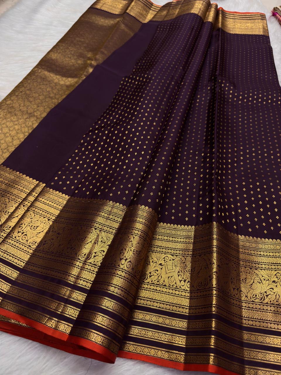 Deep Brown pure silk Kanjivaram Butta saree with purple Kanchana undertone and antique-gold zari border.