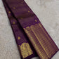 Folded Deep Aubergine Purple Pure Silk Kanchipuram saree showing fine gold Kattam lines and elaborate zari border.