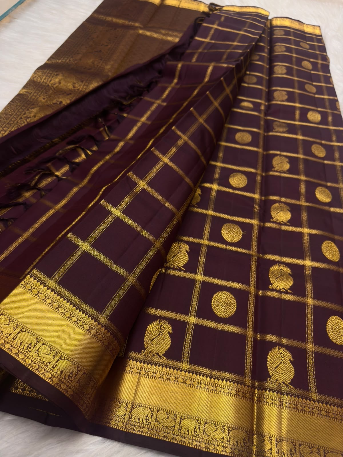 Deep aubergine Zari Kattam Kanchipuram saree with Mayil Chakram, close-up