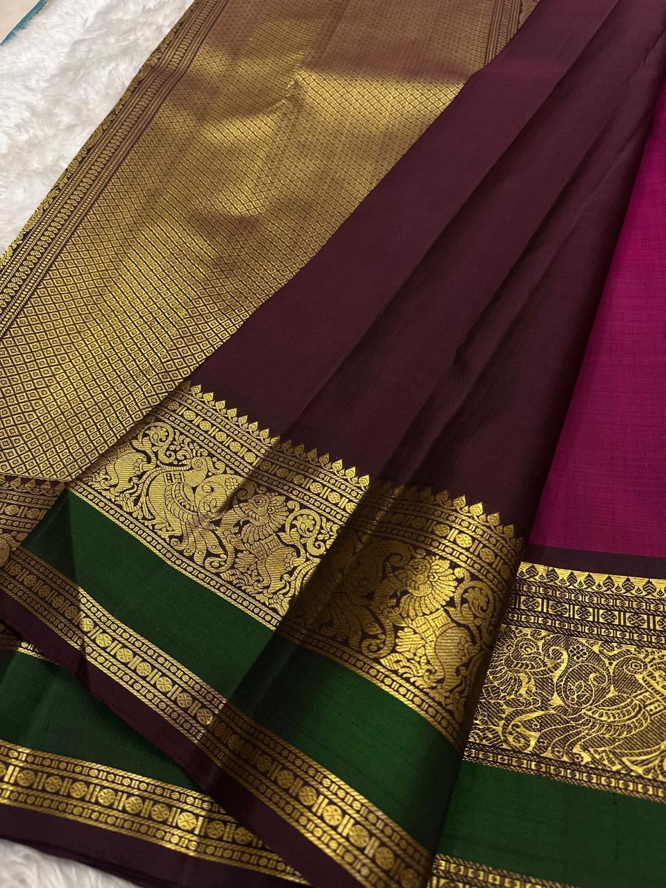 Kanchipattu silk saree in korvai with deep berry pink border weave traditional zari detail