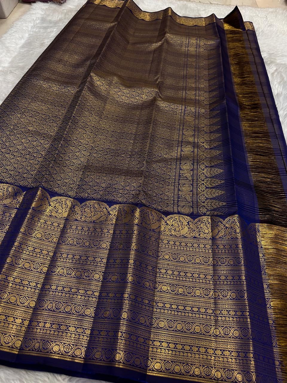 Dense classic-gold ornamental border against Deep Neelam Blue Pure Silk.