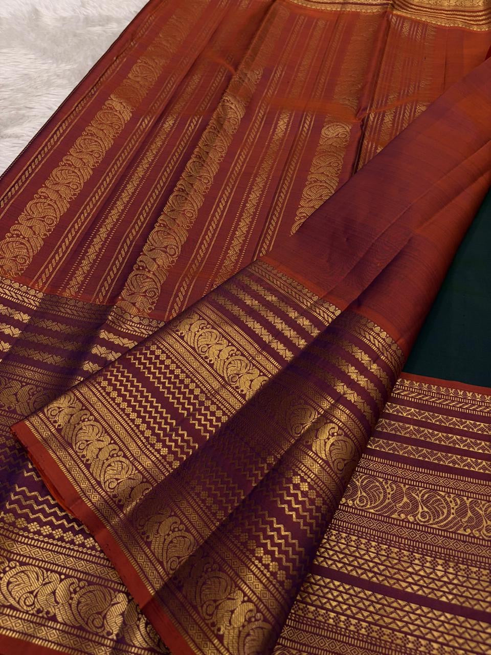 Mayil Butta peacock motif in gold zari on deep bottle green Varisaipet body