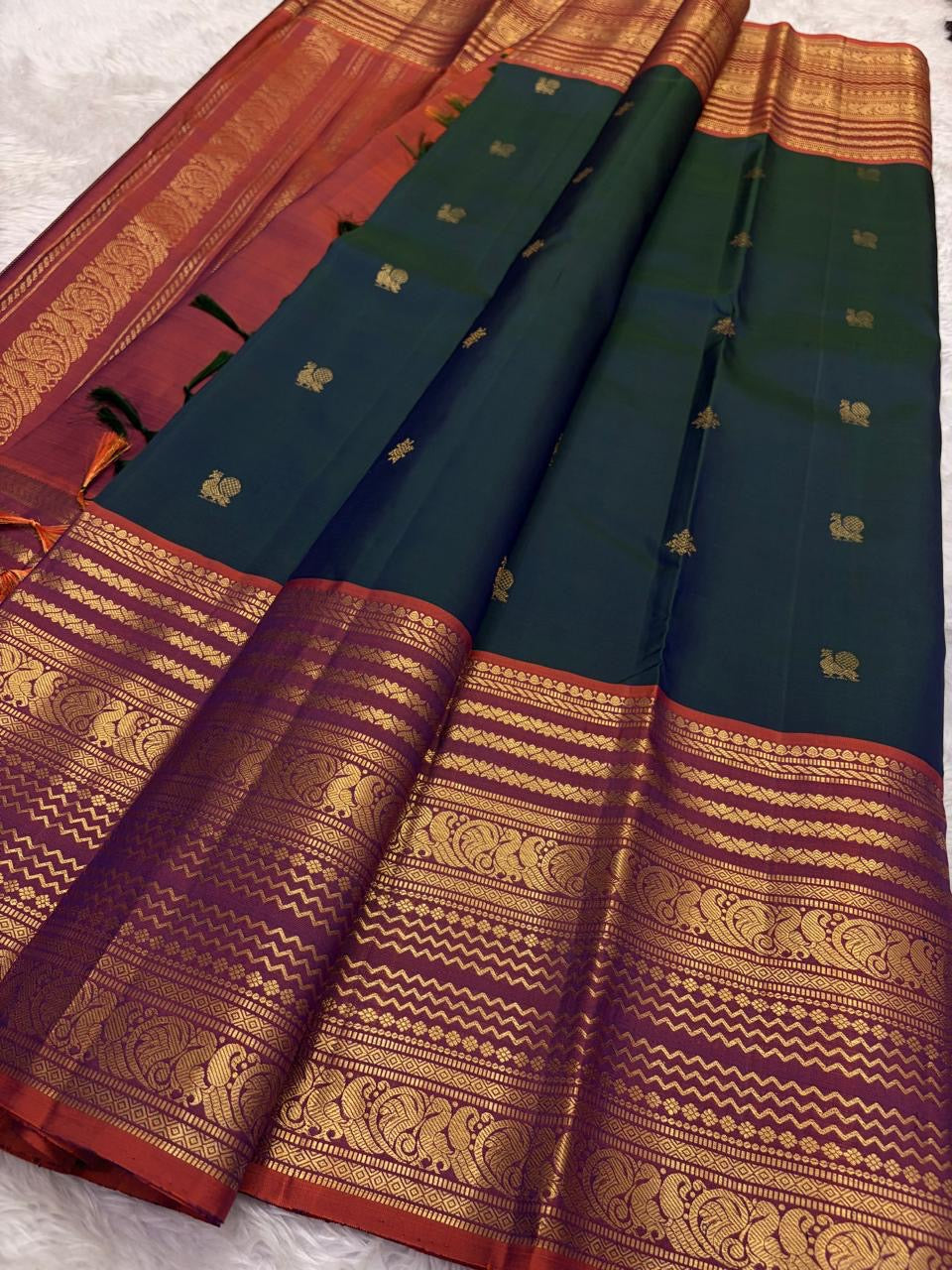Deep bottle green handwoven pure silk Kanjivaram saree with Varisaipet Mayil Butta and rust orange border — Idam Living
