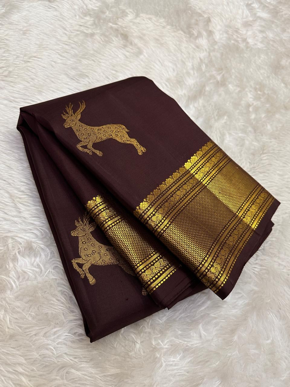 Deep brown Pure Silk Kancheepuram Butta saree with bounding deer motif and wide grey-toned zari border