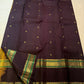 Emerald Green bands framing gold-zari registers, silk thread intertwined with the zari.
