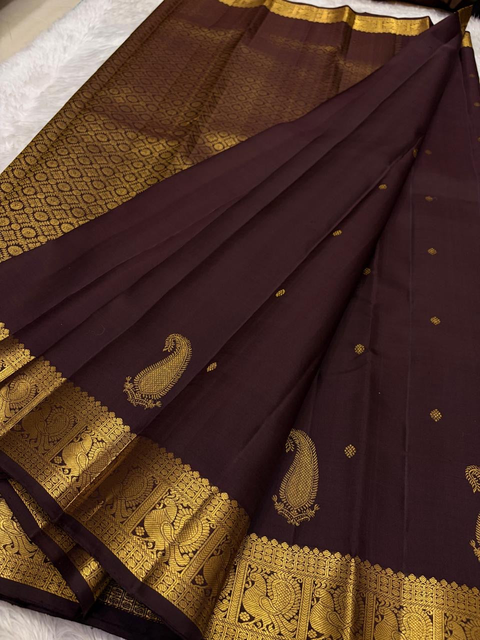 Close view of handwoven gold zari paisley buttas across Deep Kanchana Brown pure silk