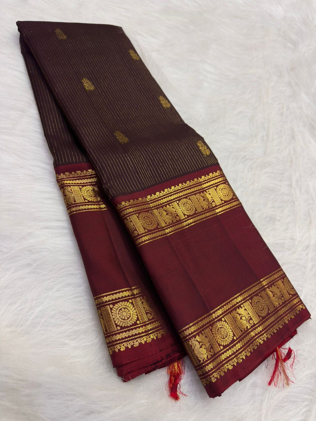 Deep brown handwoven Pure Silk Kanchi Pattu saree with fine Zari Kattam lines and an Arakku Rettapet border.