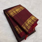 Arakku Rettapet border on a deep coffee-brown Kanchipuram silk saree with traditional woven registers.