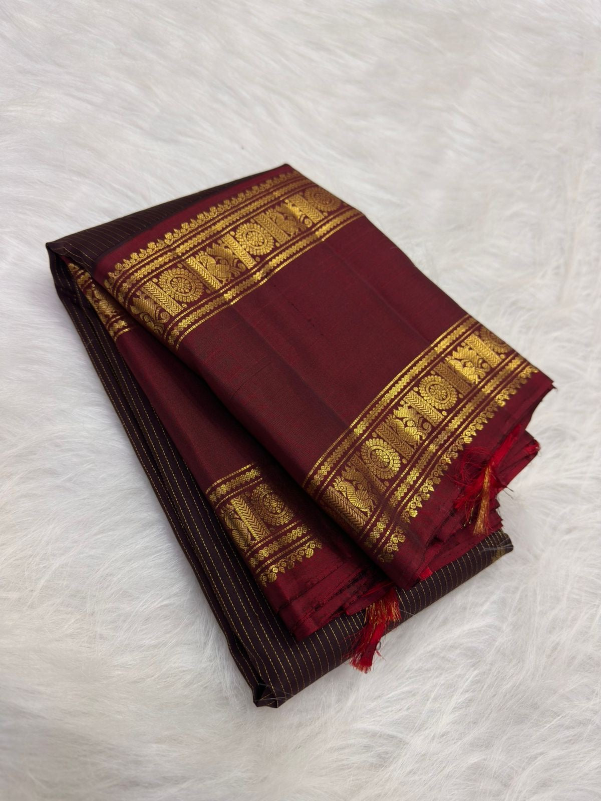 Arakku Rettapet border on a deep coffee-brown Kanchipuram silk saree with traditional woven registers.