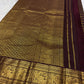 Deep brown Kanchipuram silk with structured gold zari checks and richly woven Kodi-Valli Mayil border