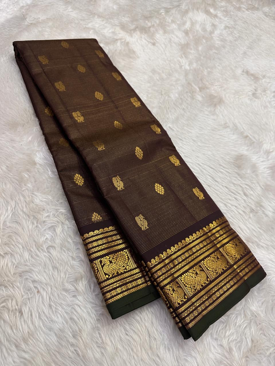 Deep brown handwoven Kanjivaram saree with antique gold zari border