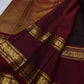 Deep brown Kanjivaram silk saree showing the Rettapet border against the fine zari-lined body.