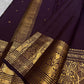 Curling floral-vine classic-gold zari ornament along the traditional border.