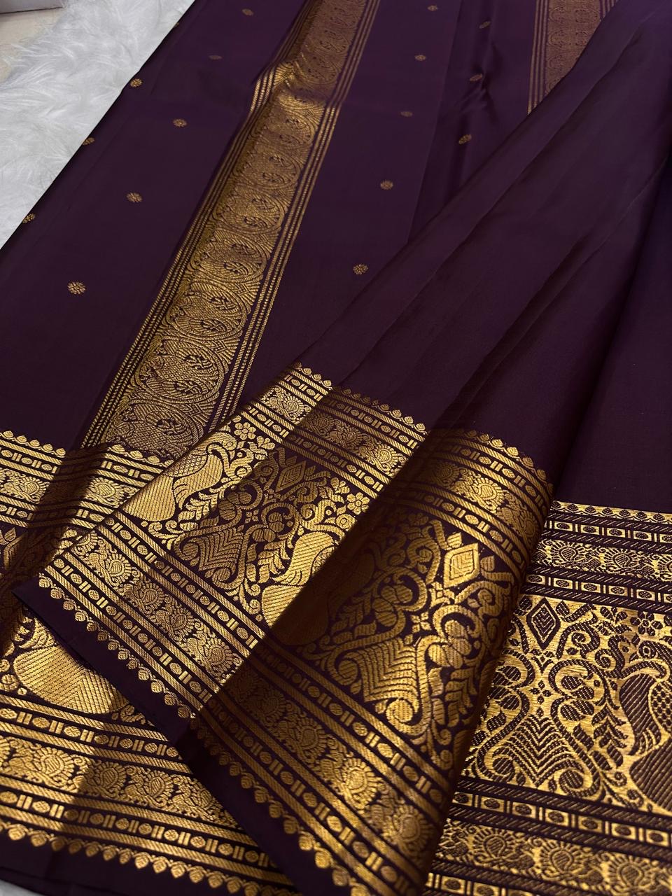 Curling floral-vine classic-gold zari ornament along the traditional border.