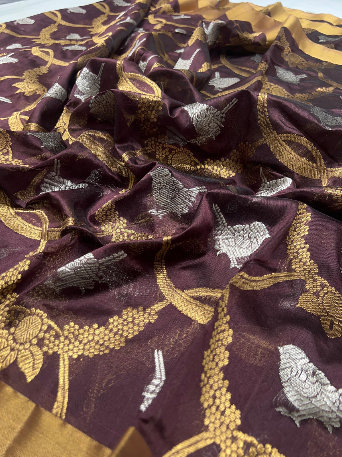 Deep Cocoa Brown Pattu Silk Chanderi saree showing the broad antique-gold woven border.