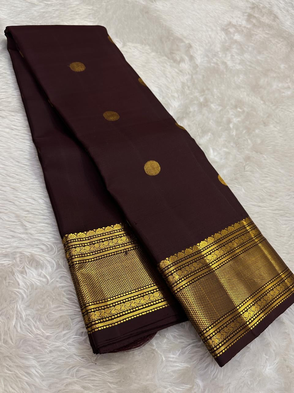 Deep brown Pure Silk Kanjivaram saree with aligned Pavun zari buttas and maroon-toned border